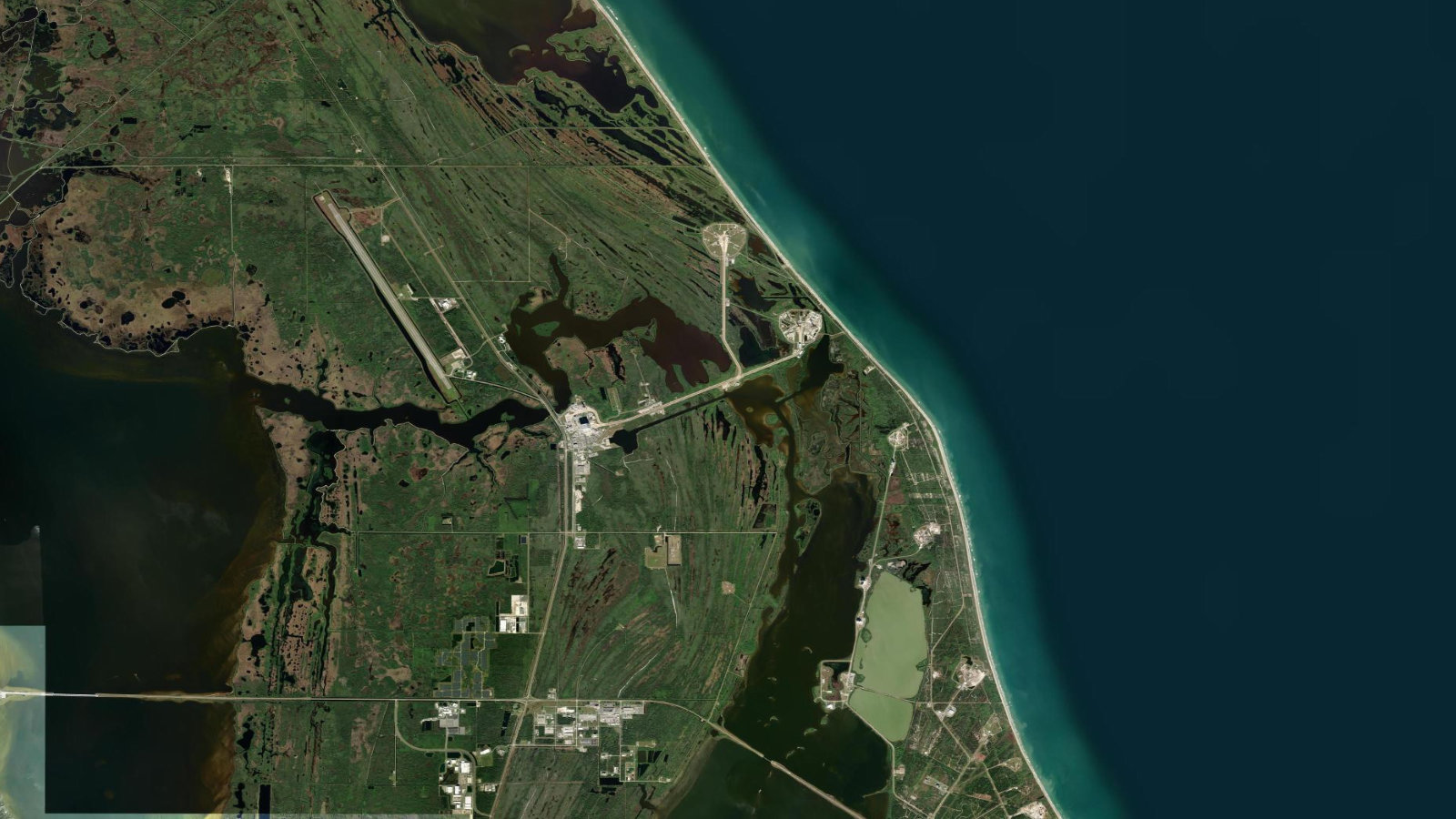 Satellite view of the launch complexes at Cape Canaveral, Florida, the pads that set the cadence for Amazon Leo deployments.
