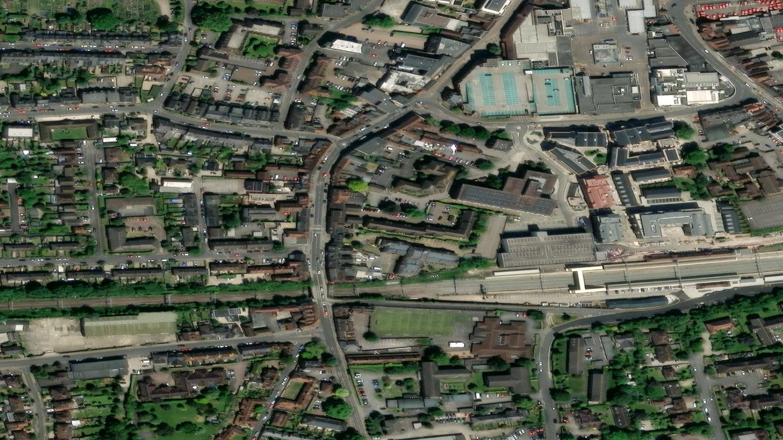Satellite view of Newbury, Berkshire, the town around Vodafone's UK headquarters, with the rail line and station running through it.