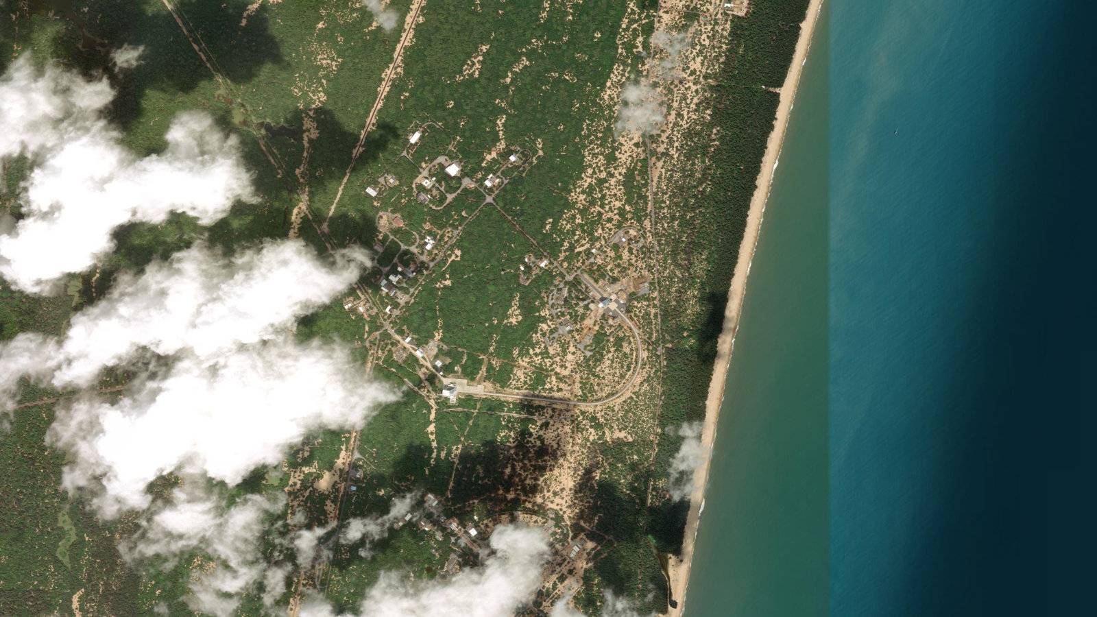 Satellite view of the Satish Dhawan Space Centre on Sriharikota island, with launch facilities set against the Bay of Bengal coast.